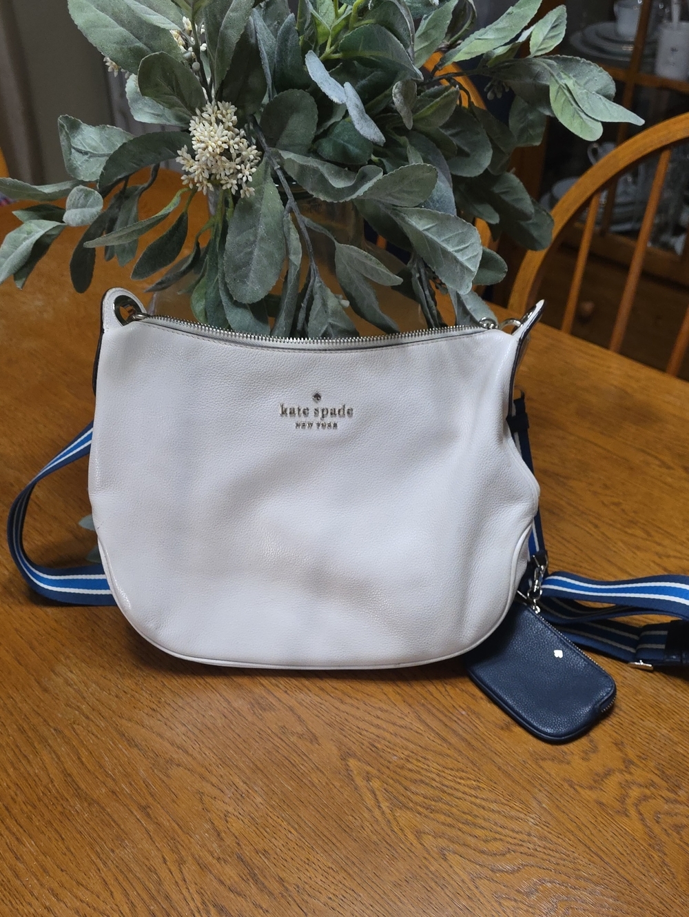 kate spade cream leather crossbody with navy striped strap and navy pouch